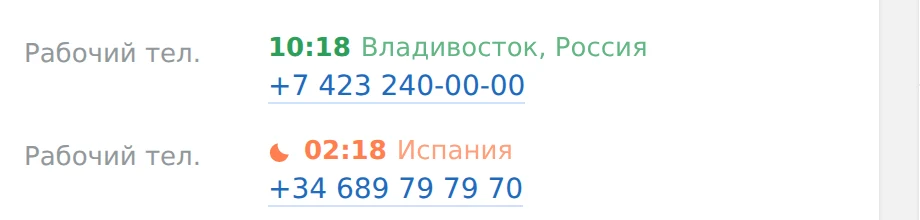 Два номера телефона в карточке: над первым «10:18 Владивосток, Россия» зелёным, над вторым «02:18 Испания» коралловым со значком луны